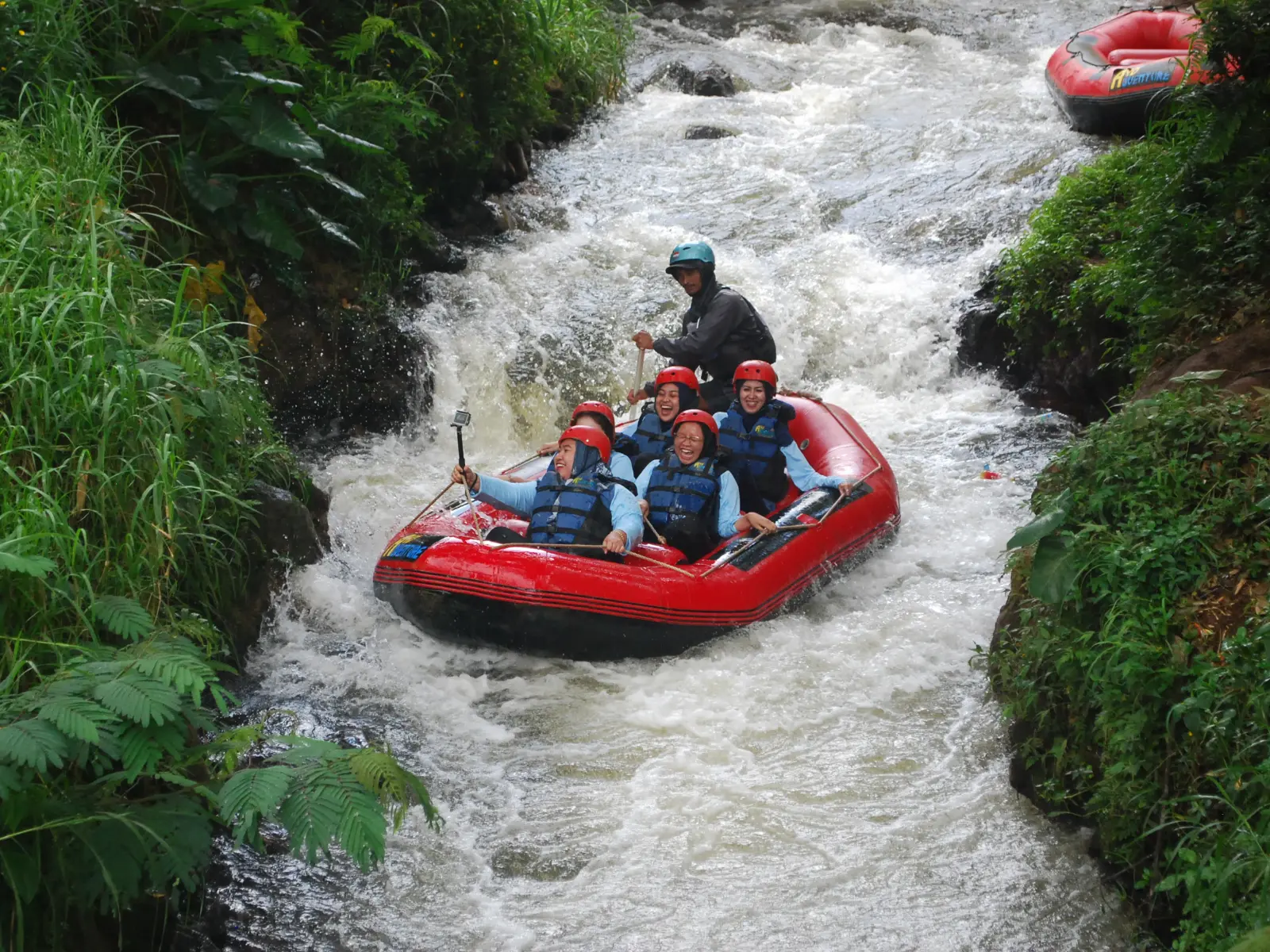 Peserta open trip rafting Pangalengan menyusuri sungai dengan perahu karet