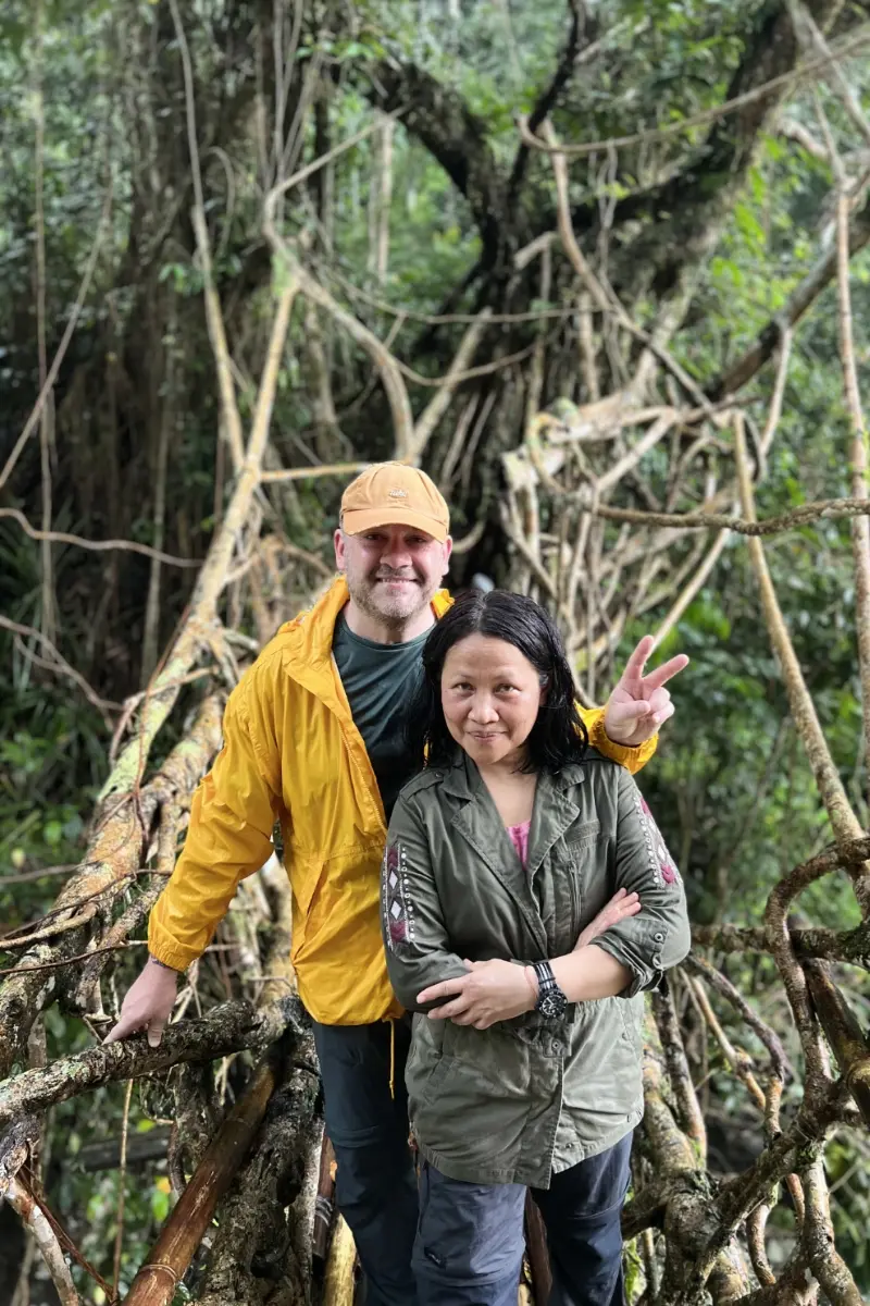 Private trip guests posing on a natural root bridge in Baduy