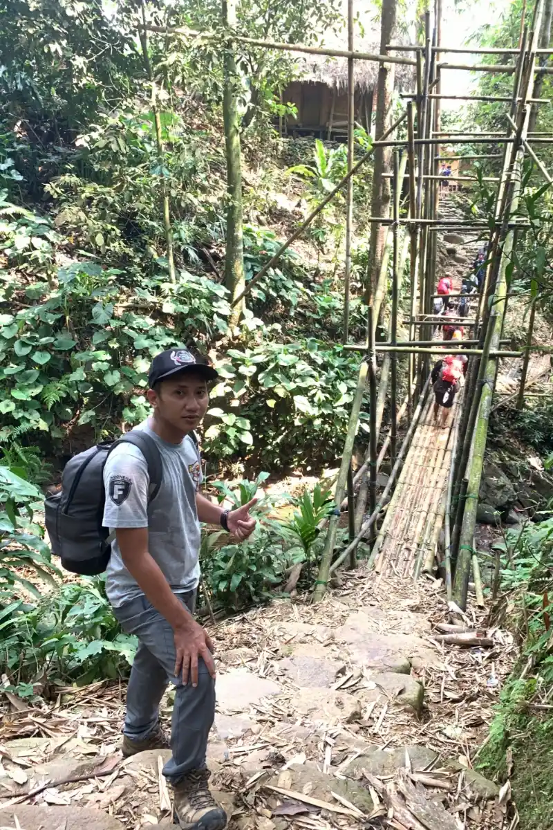 Private trip guests posing on a bamboo bridge in Baduy Luar